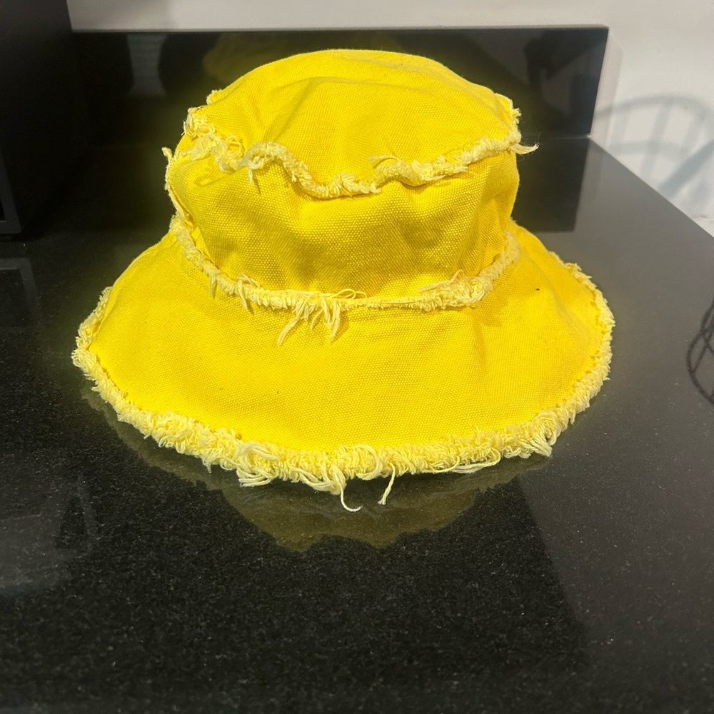 NWT Jocelyn Bright yellow bucket hat with frayed edges.